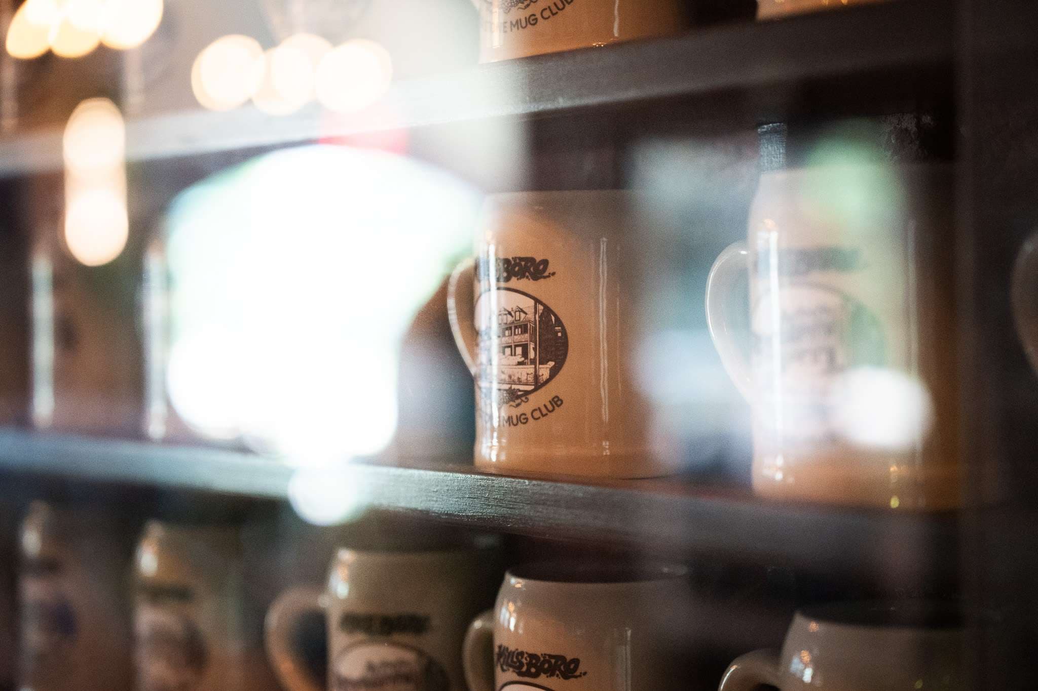 Mug Club steins on the taproom shelf